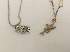 Silver and golden necklaces with silver mask and fish pendant respectively picture