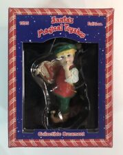 1995 Santa's Magical Toy Shop Christmas Ornament Elf Holding a Cookie with Joy picture