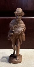 Vintage Carved Wood Sculpture Of an Old Man With Backpack picture