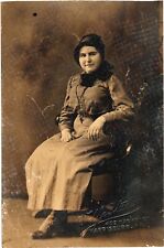 An Old Photograph of A Woman Wearing a Hat And Sitting Postcard picture