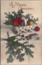 1922 MERRY CHRISTMAS Greetings Postcard Pine Boughs /Gift Basket - Colored Photo picture