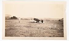 VINTAGE B&W SNAPSHOT 1932 SMALL BI-PLANE PILOT TAKING OFF IN DIRT FIELD picture