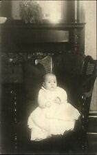 RPPC ~ Wide-eyed baby on cane-back chair ~ real photo postcard picture