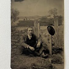 Antique Tintype Photograph Handsome Young Man Sitting On Ground Prop Fence Hat picture