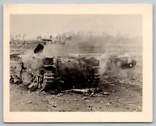 WW2 disabled American tank with a partially ran over Japanese corpse. picture