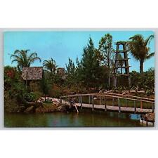 Postcard FL Indian Rocks Beach Tiki Garden Hibiscus Parakeet Bell Tower picture