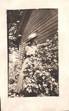 Vintage Postcard One Fine Day In The Yard Woman Picking Up Flowers picture
