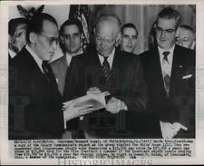 1954 Press Photo Pres.Eisenhower with a copy of the Salary Commission Report picture