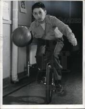 1953 Press Photo Gene Maceoff for basketball on unicycle act picture