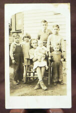 c1909 RPPC Family of 7 children - No Smiles - all wearing shoes - Real Photo picture