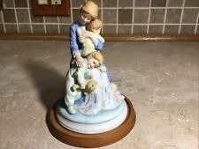 Holly Hobbie -- 1985 IN A MOTHERS ARMS - Wood Base  Figurine- 6” Tall picture