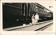 Railroad RPPC couple in front of a train Real Photo Post Card Vintage picture