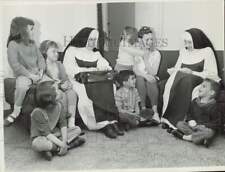 1966 Press Photo Nuns speak with a mother and her children in Cleveland, Ohio picture