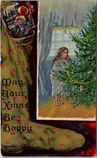 Vintage 1910s CHRISTMAS Embossed Postcard Girl at Xmas Tree / Stocking - UNUSED picture