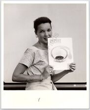 1950s Black And White Photo Woman Holding Up A Dupont Magazine picture