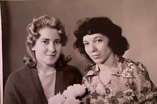 Portrait of two beautiful girls with flowers .      1977      Vintage picture