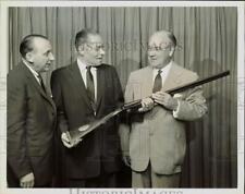 1957 Press Photo Dr. Logan Bennett presented Winchester shotgun by John Olin. picture