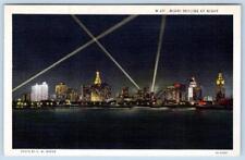 1940-50's MIAMI FLORIDA SKYLINE AT NIGHT SEARCHLIGHTS VINTAGE LINEN POSTCARD picture