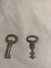 Two small keys, 1 and 1.25 inches long picture