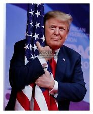 PRESIDENT DONALD TRUMP HUGGING AMERICAN FLAG 8X10 PHOTO picture