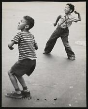 Photo:Two unidentified boys throwing picture