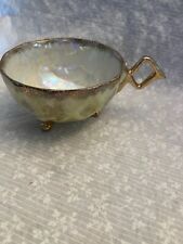 tea cup unmarked. Vintage lusterware yellow with gold. Crossed handle. 3 feet. picture