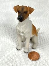Miniature resin orange & white dog with a dark muzzle & black nose. 3 1/4