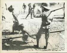 1935 Press Photo Soldier shoos women and children from train track at Ethiopia picture