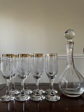 Eight (8) Gold Rimmed flutes with etched design and matching decanter picture