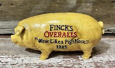 FINCK’S OVERALLS ~ Wear Like A Pig’s Nose ~ Cast Iron Piggy Bank, 3.75” x 8” picture