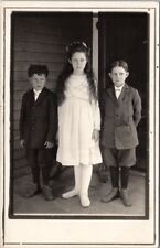 1910s RPPC Photo Postcard 3 Kids in Sunday Clothes on Porch - Amazing Faces picture