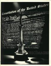 1990 Press Photo Scales Displayed with the Constitution of the United States picture