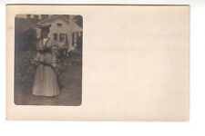RPPC Postcard: Dressed wwoman with parasol in front of home - exterior picture