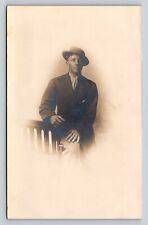 c1911 RPPC Man Sits on Arm of Chair in Suit and Tilted Hat ANTIQUE Postcard picture