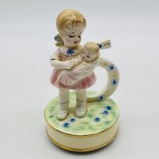 5 Year Old Girl Holding A Baby Japan Music Box picture