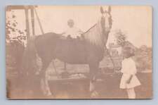 Little Girl w Baby Sibling Riding Horse RPPC Woodburn Indiana Antique Photo 1908 picture