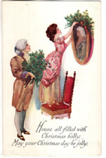 ANTIQUE A-S CHRISTMAS Postcard  LADY STANDING ON CHAIR, PLACING HOLLY ON PHOTO picture