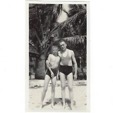 Beach day with Dad. Undated original vintage snapshot of a boy and man. picture