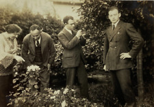 Handsome Man Posing While Others Look At Plants B&W Photograph 3 x 4.25 picture