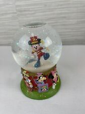 Disney snow globe Mickey marching band conductor Minnie Pinocchio Dumbo Donald picture