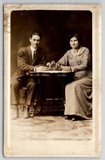 RPPC Darling Edwardian Couple Seated at Table Studio Real Photo Postcard J24 picture