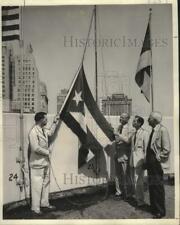 Press Photo Flags of Paraguay & Cuba hoisted over the International Trade Mart picture