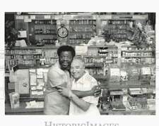1992 Press Photo William Archie hugs Seymour Fox at Harlem Drugs on 7th Avenue picture