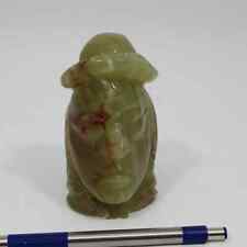 This vintage totem carved jade figurine depicts a Native head/face with a hat picture