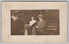 Postcard Photograph Young Woman and Man Sitting On A Park Bench Vintage Unposted picture