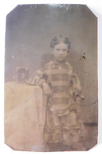 Antique Tintype of Young Girl in Plaid Dress Posing next to a Framed Photograph picture