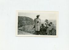 Vintage B/W Snapshot Photo - Lady Standing W/Hat - Camera - Looking at view  picture
