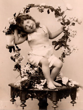 c1908 RPPC Studio Photo Postcard: Adorable Kid Sits In A Floral Designed Basket picture