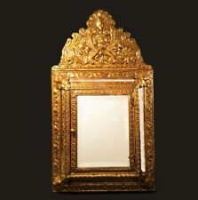 Antique cushion mirror. French style with cabinet door. Gleaming brass repousse. picture