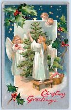 1910's TUCK'S*CHRISTMAS GREETINGS*ANGELS TRIMMING TREE*CANDLES*EMBOSSED*POSTCARD picture